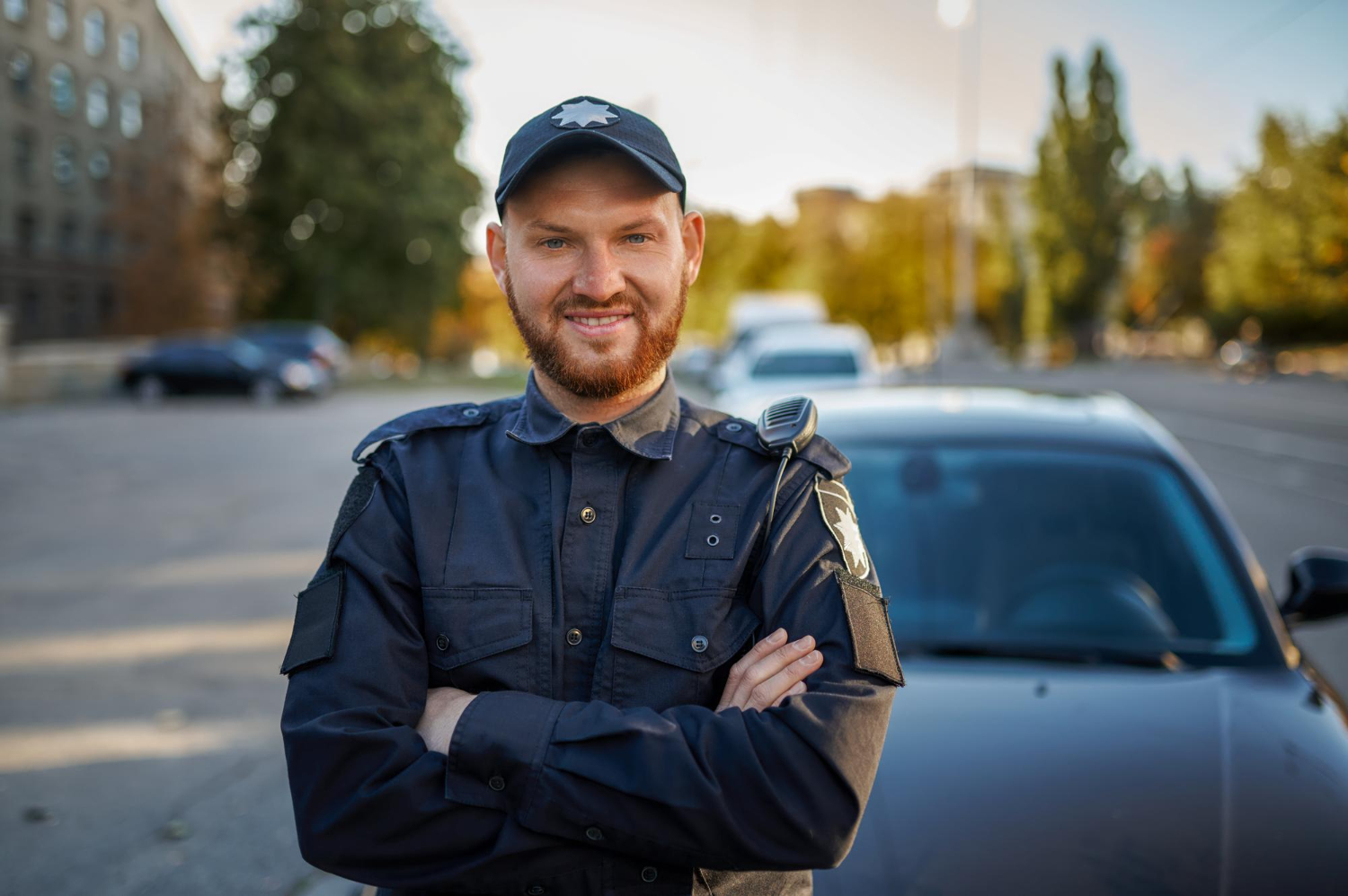 male-police-officer-uniform-poses-near-car